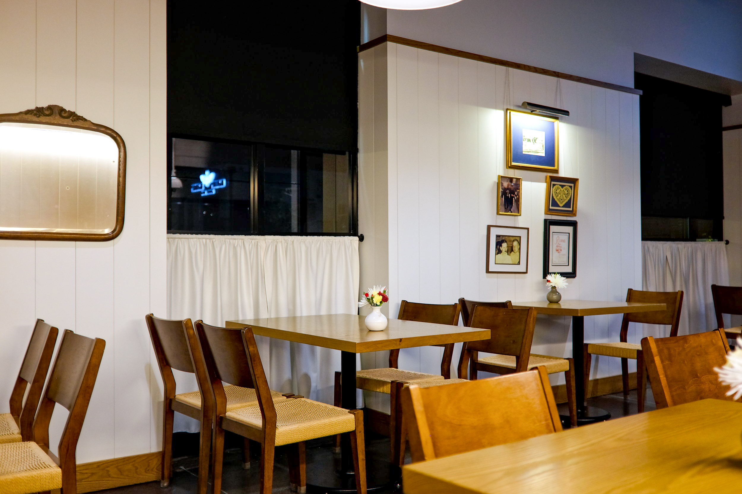 The dining room at Restaurant Constance with family photos and folk art on the walls