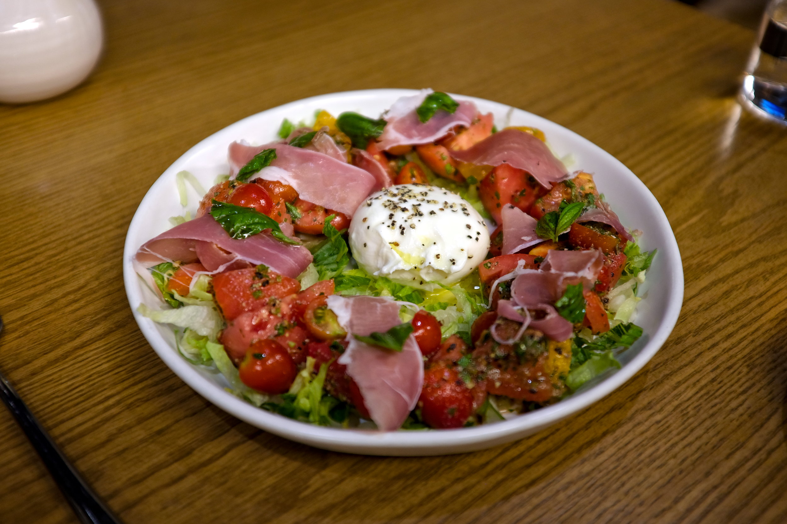 A salad with tomato and burrata