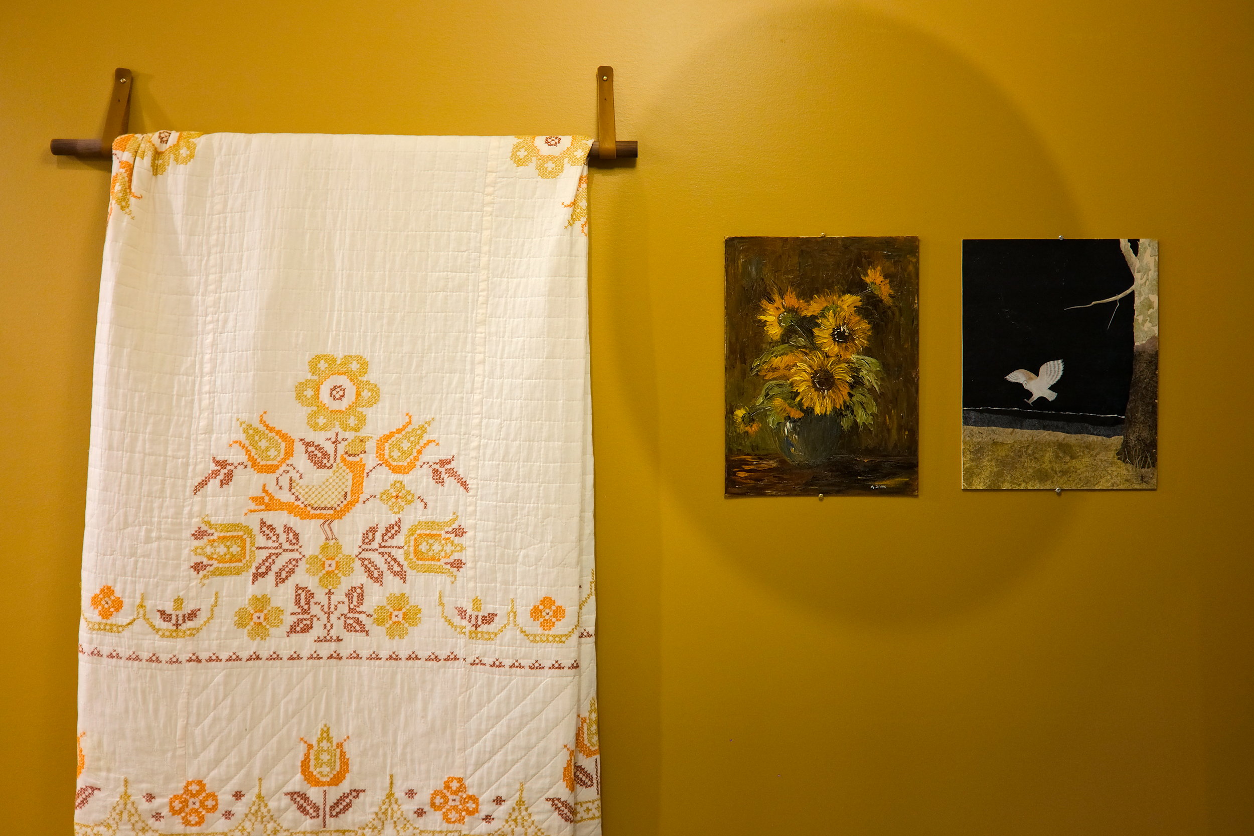 A quilt and two paintings in the cabin