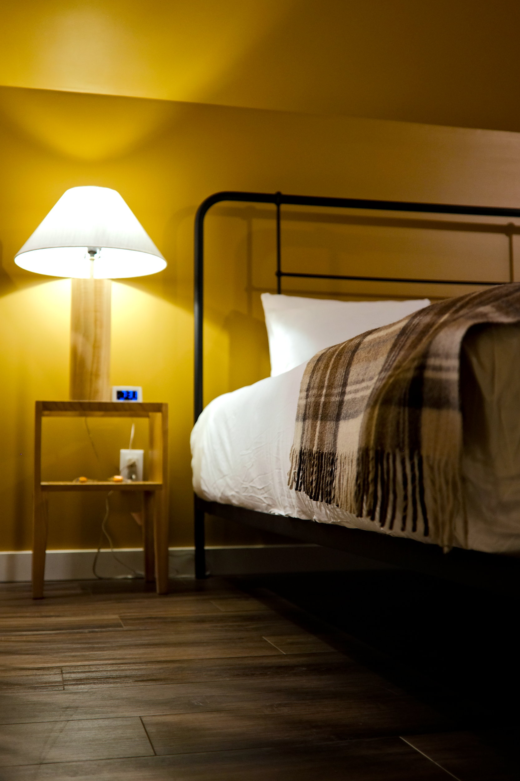 The Queen bed and nightstand in the Spruce cabin