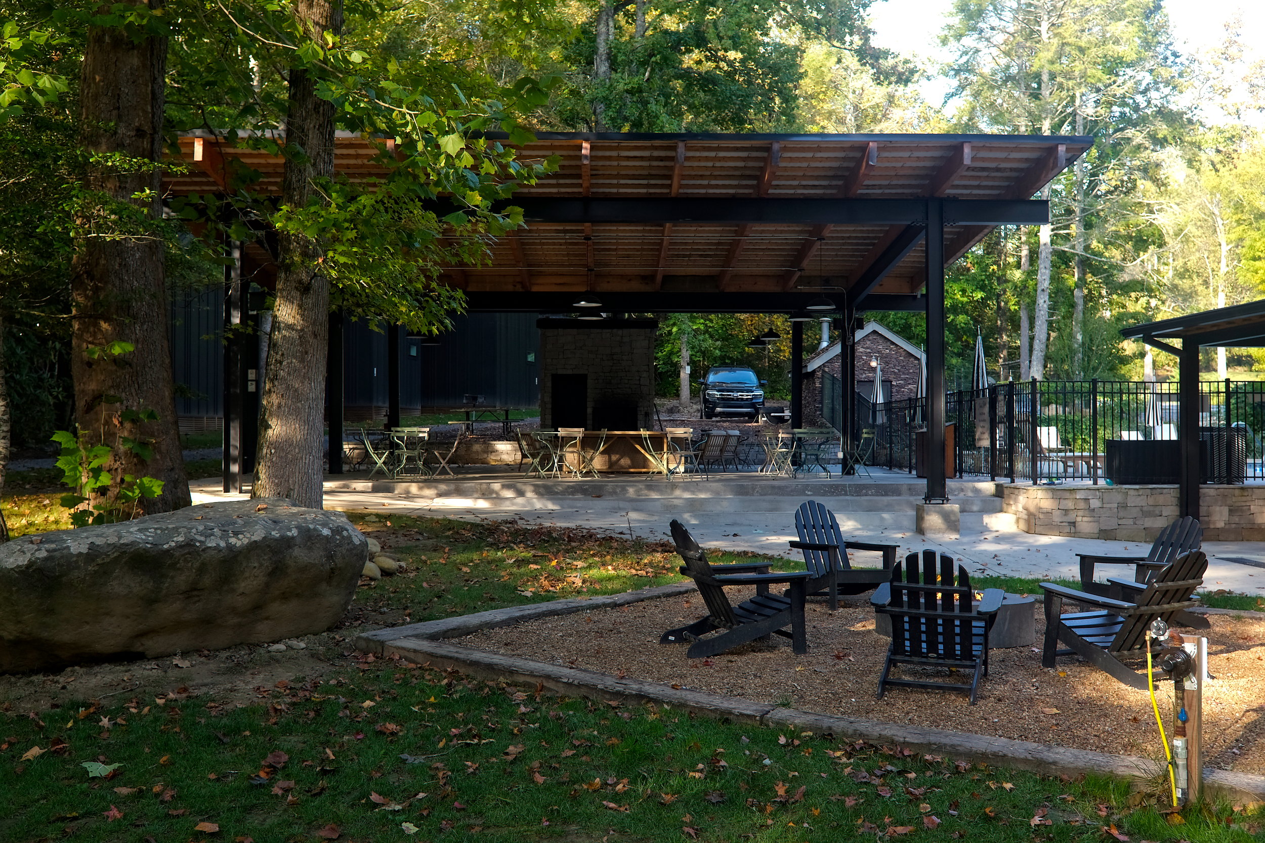 A fire pit with a pavilion in the background 