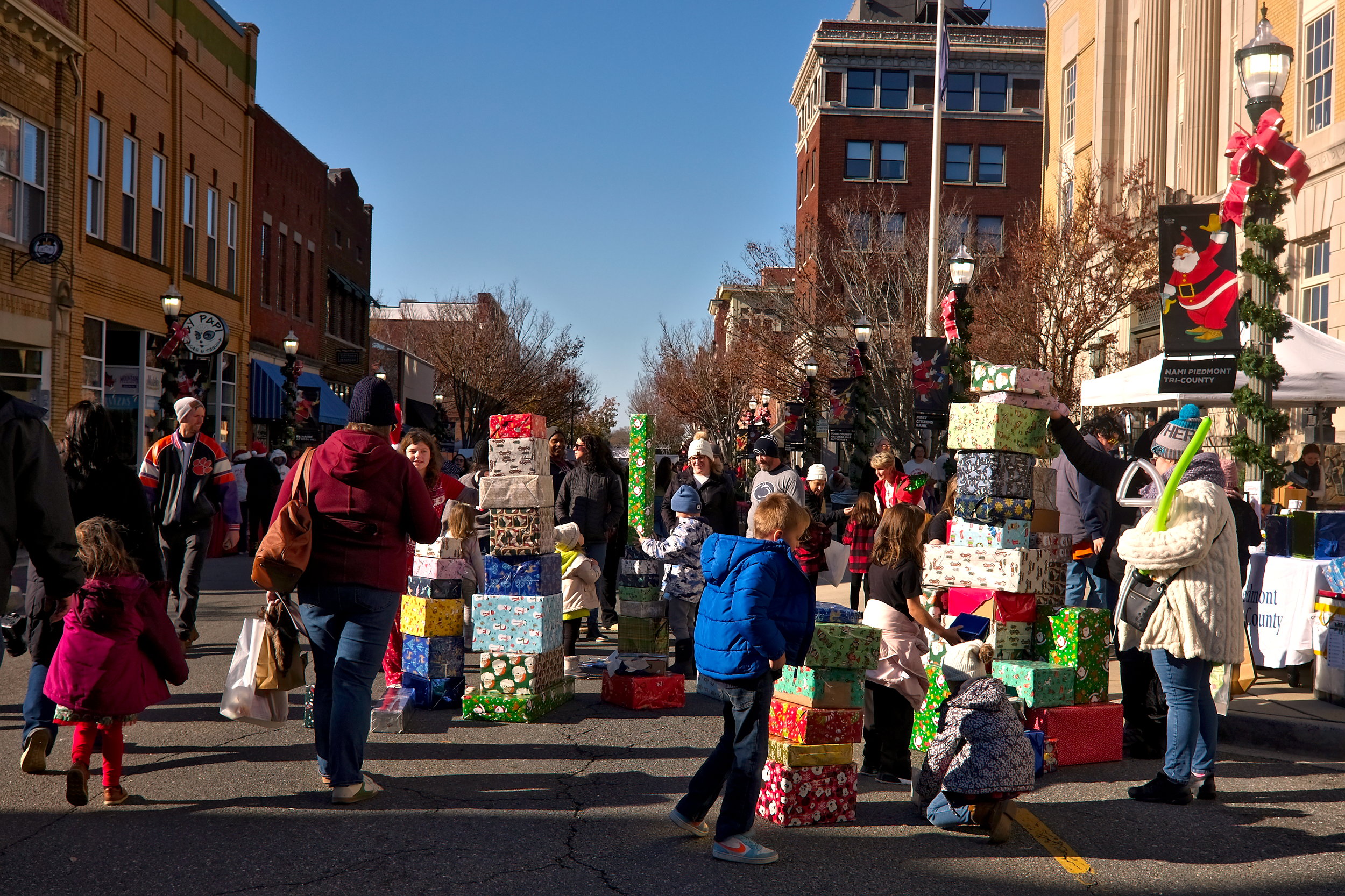 A group of kids stack wrapped boxes for fun