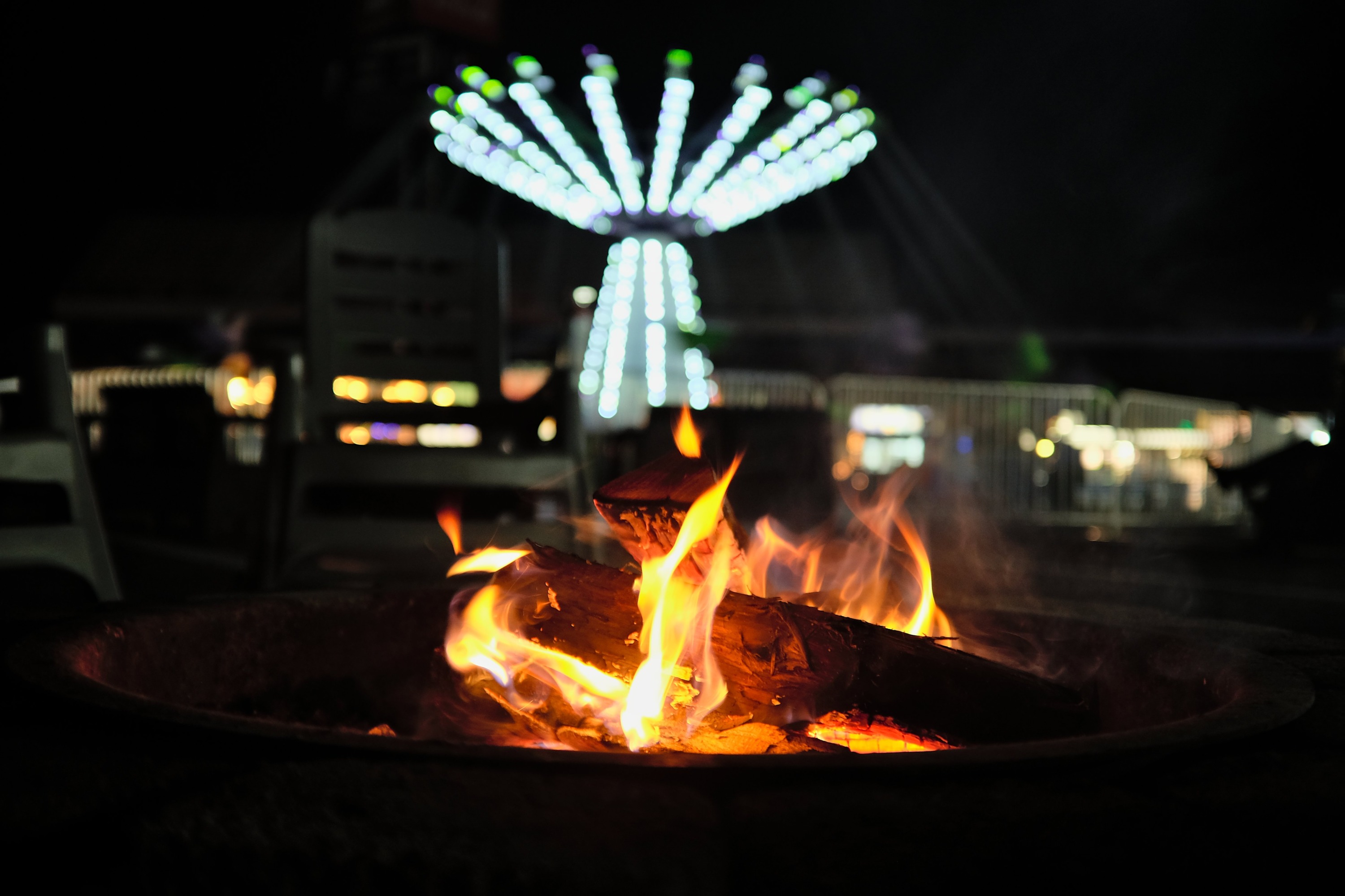 A fire pit and fair rides at Speedway Christmas