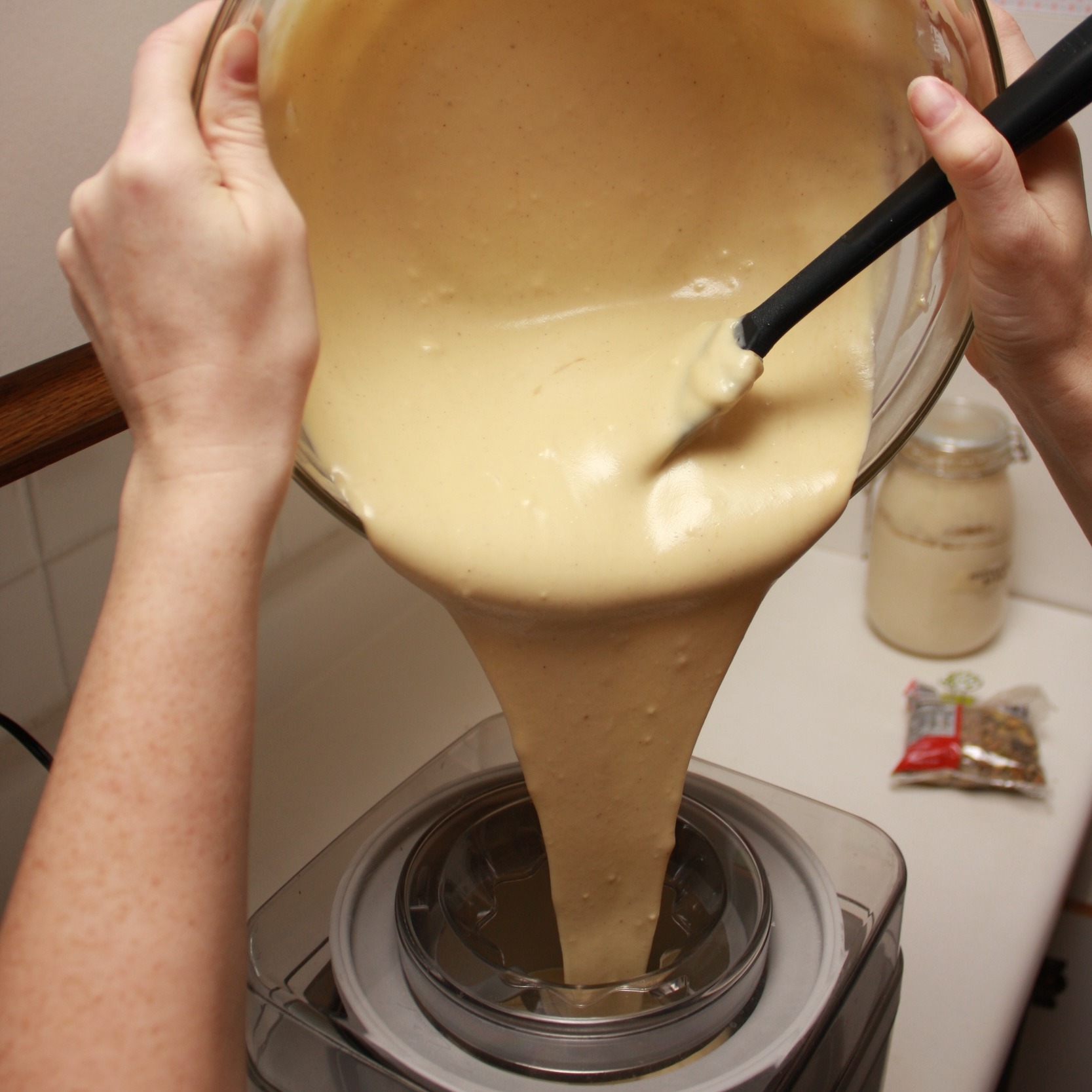 Alyssa pours the ice cream base into the maker