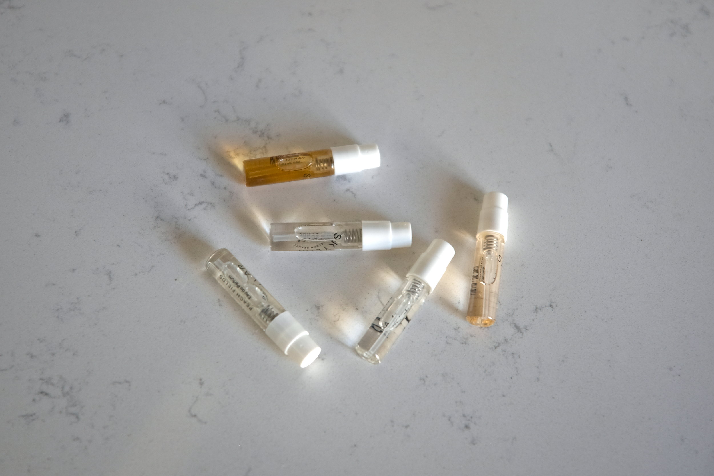 All five Skylar Perfume samples on a marble counter