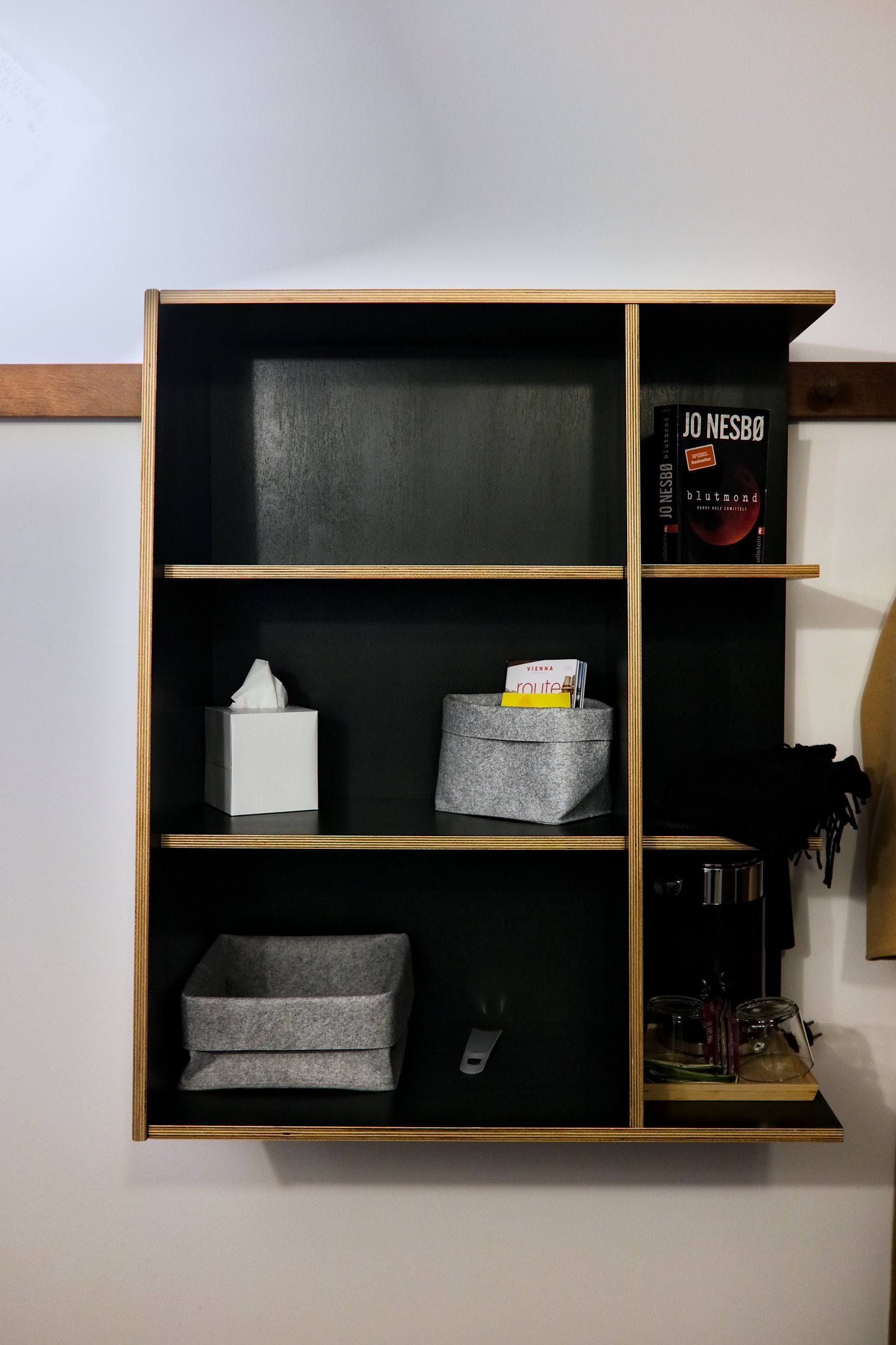 Shelves with a tea kettle, shoe horn, maps, and more