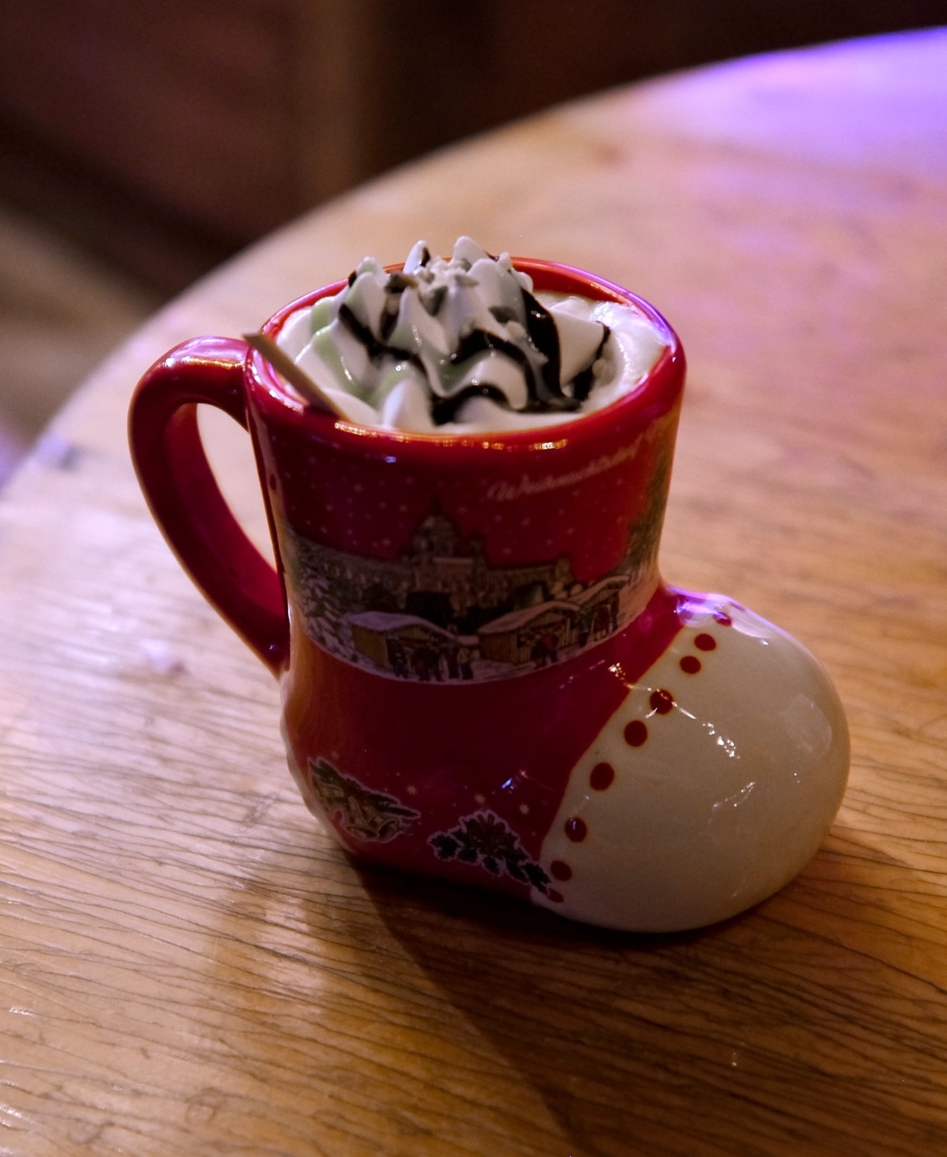 A stocking-shaped mug of punsch with whipped cream