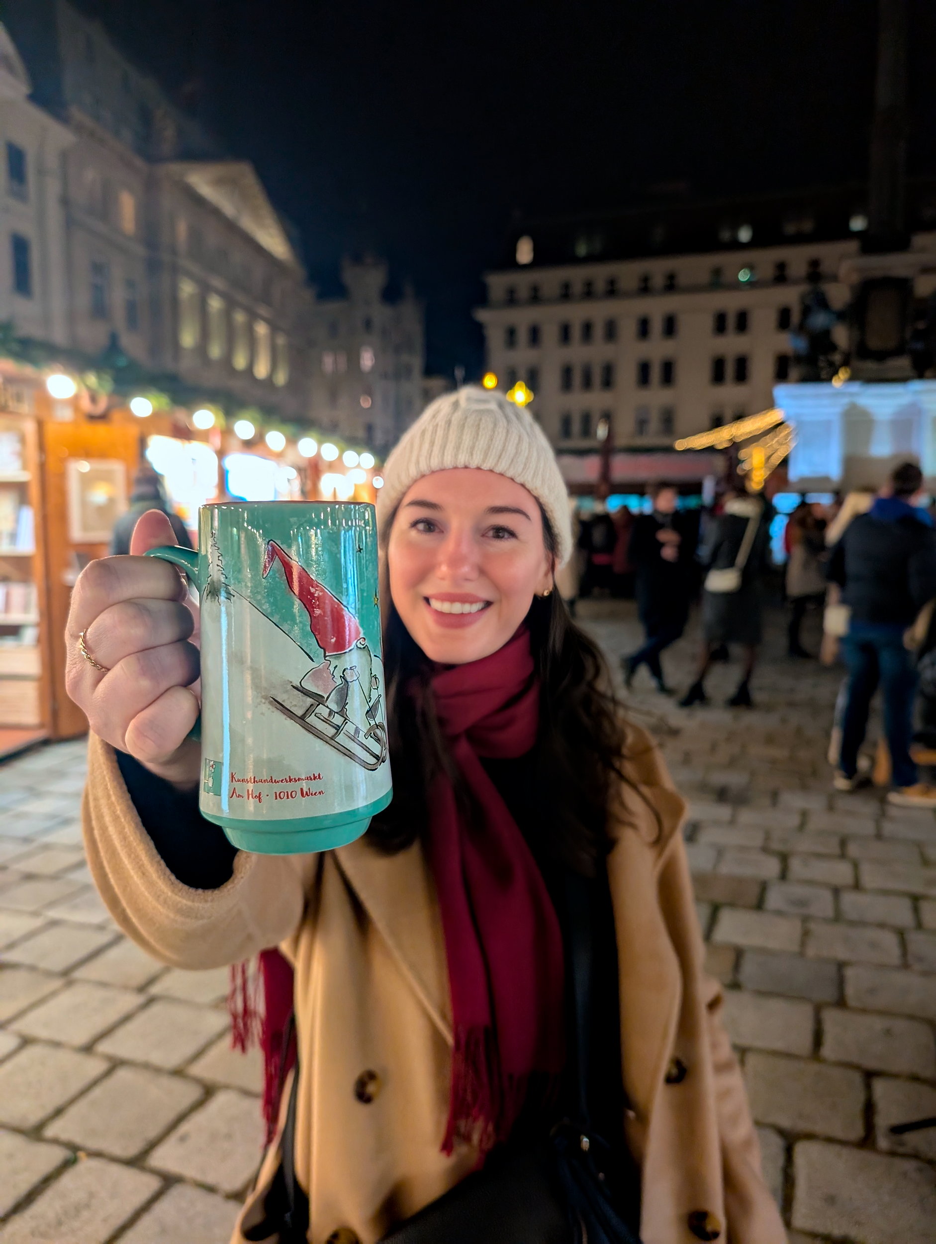 Alyssa holds up a mug at Am Hof market