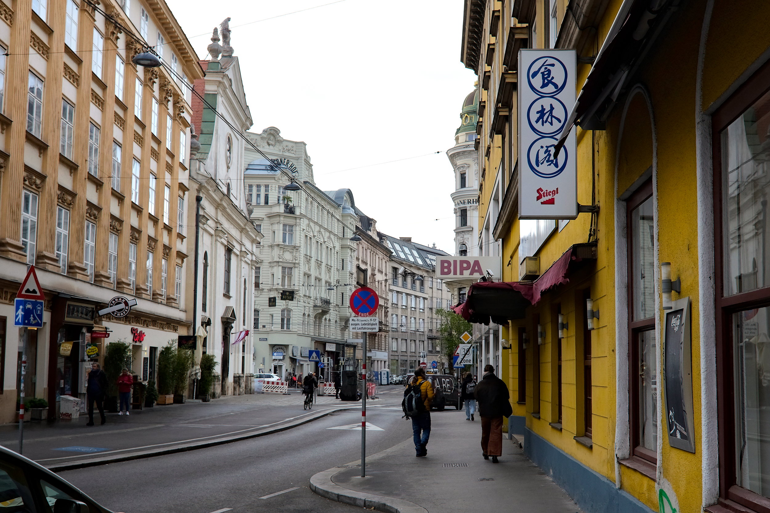 People walk down a street in Vienna