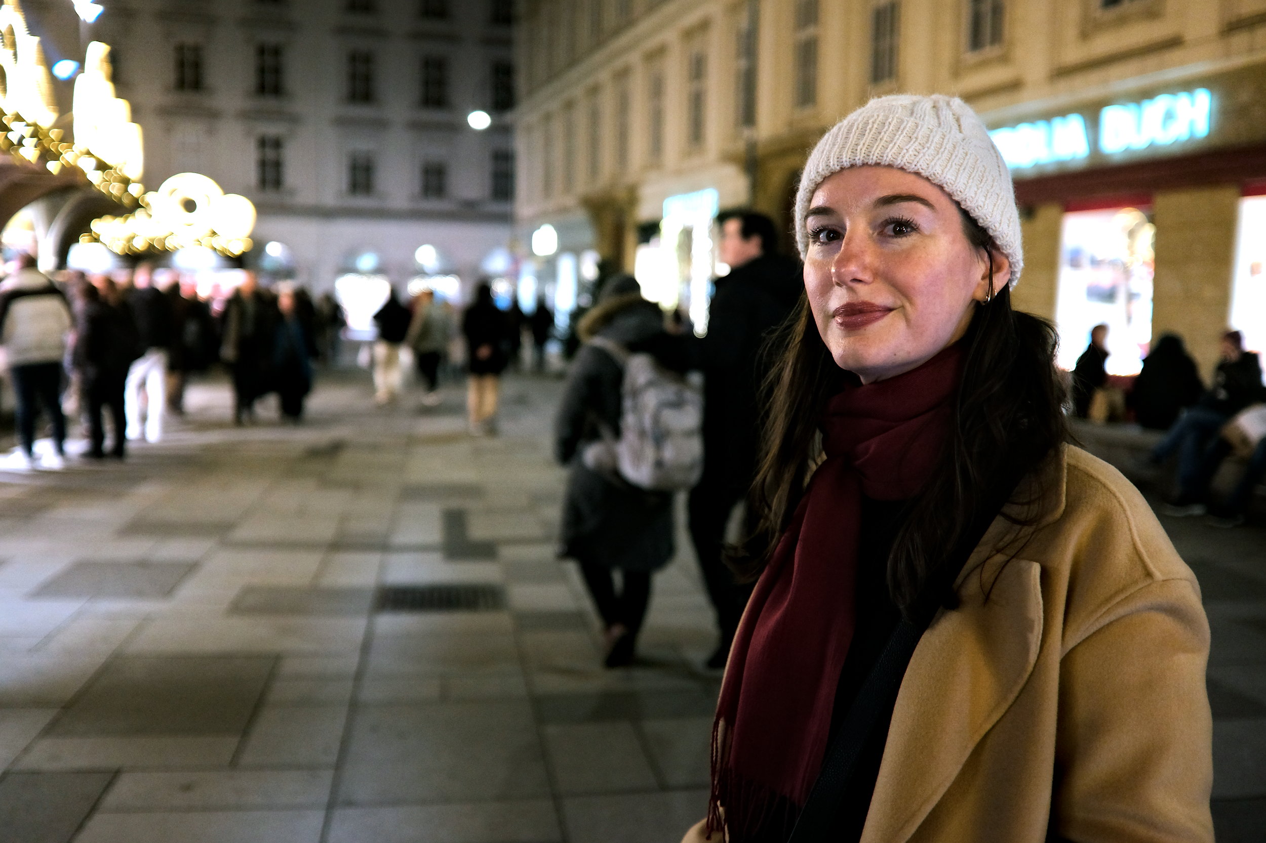 Alyssa wears a hat and scarf at the Stephansplatz Christmas market