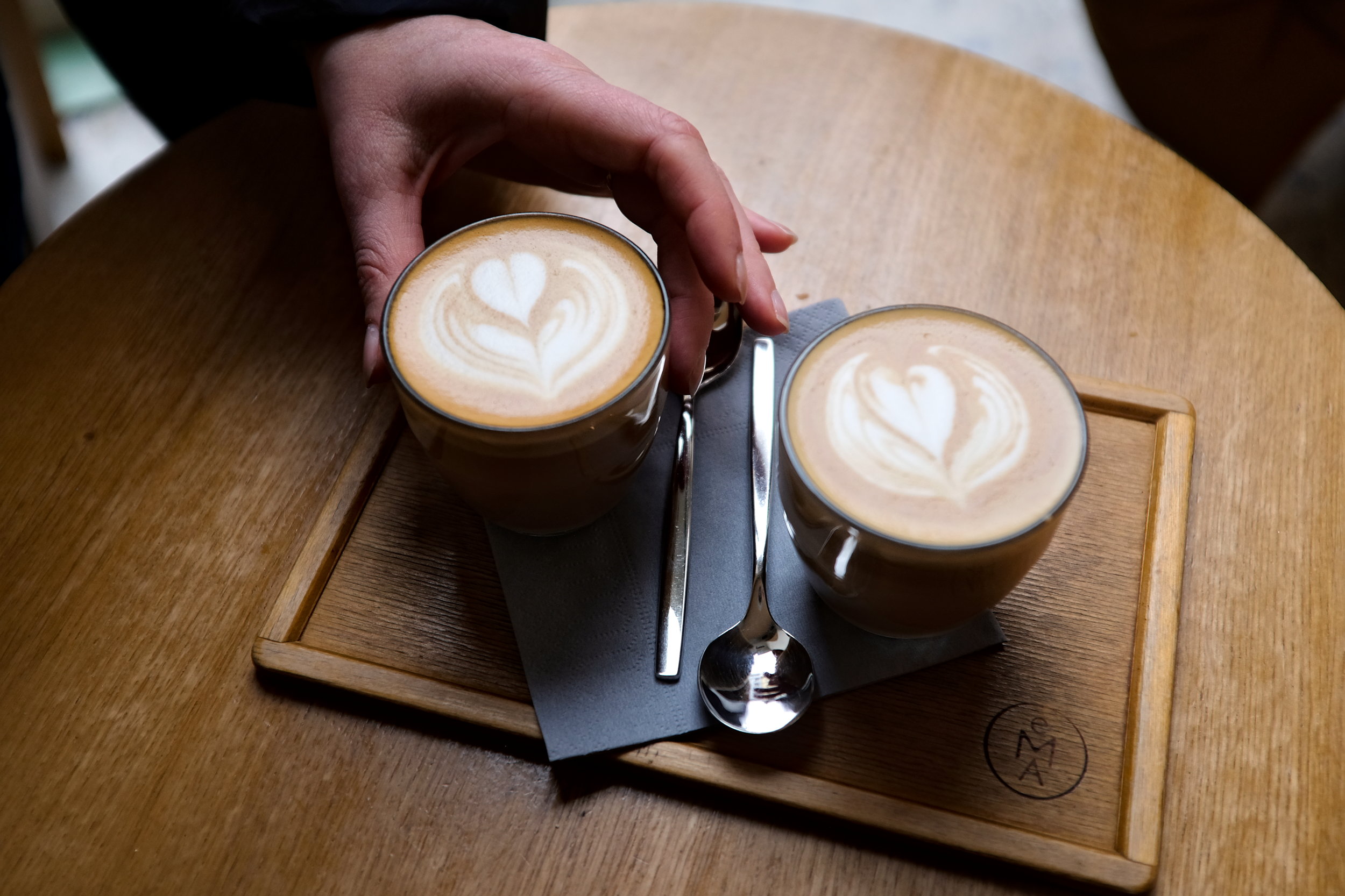 Alyssa picks up a cup of coffee at EMA