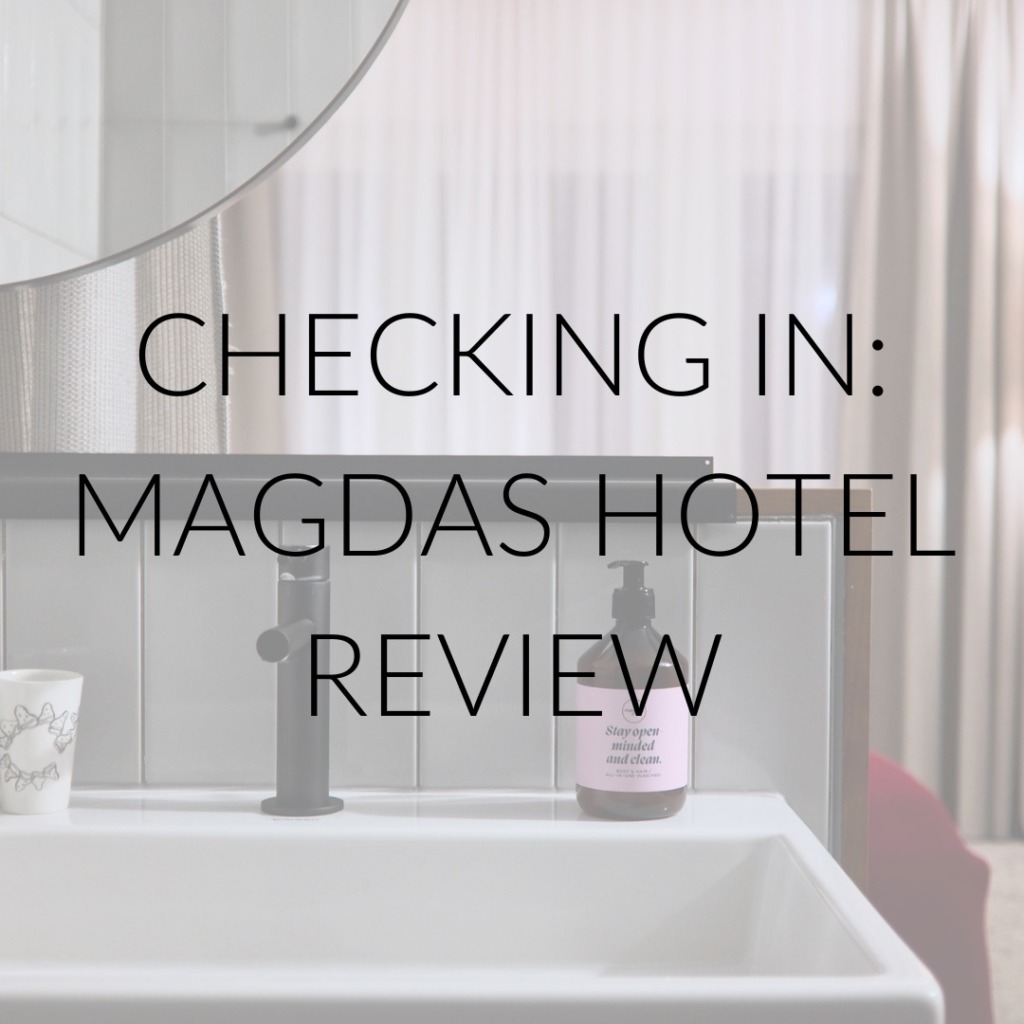 A room at magdas hotel with text overlay "Checking In: Magdas Hotel Review"