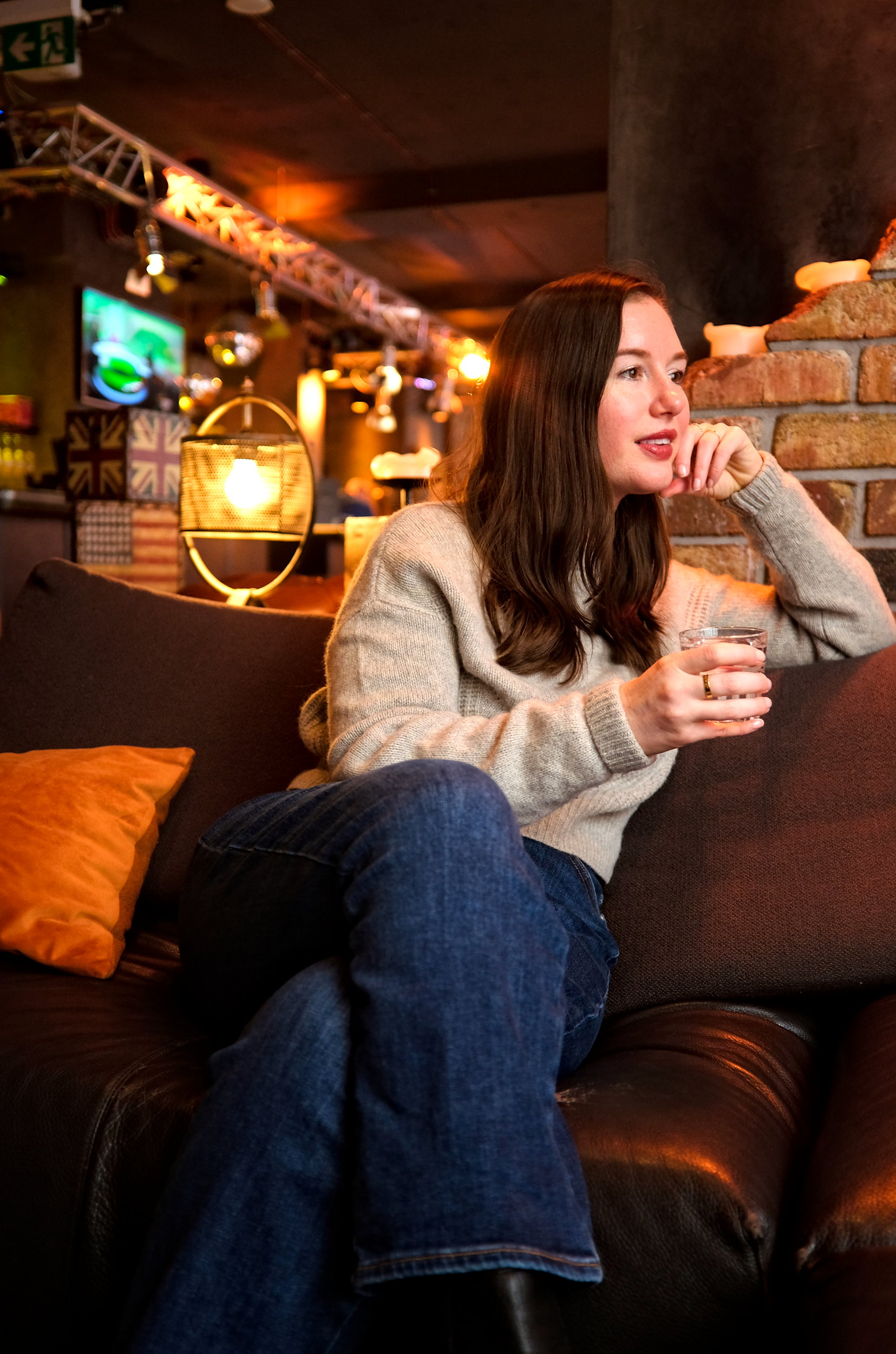 Alyssa sits in the lounge with a drink