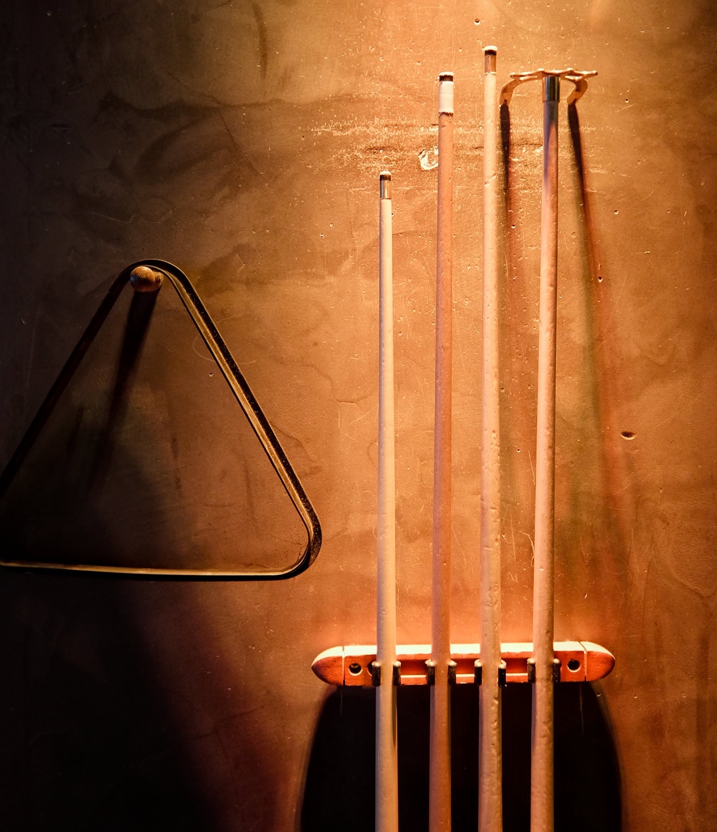 A rack of pool cues