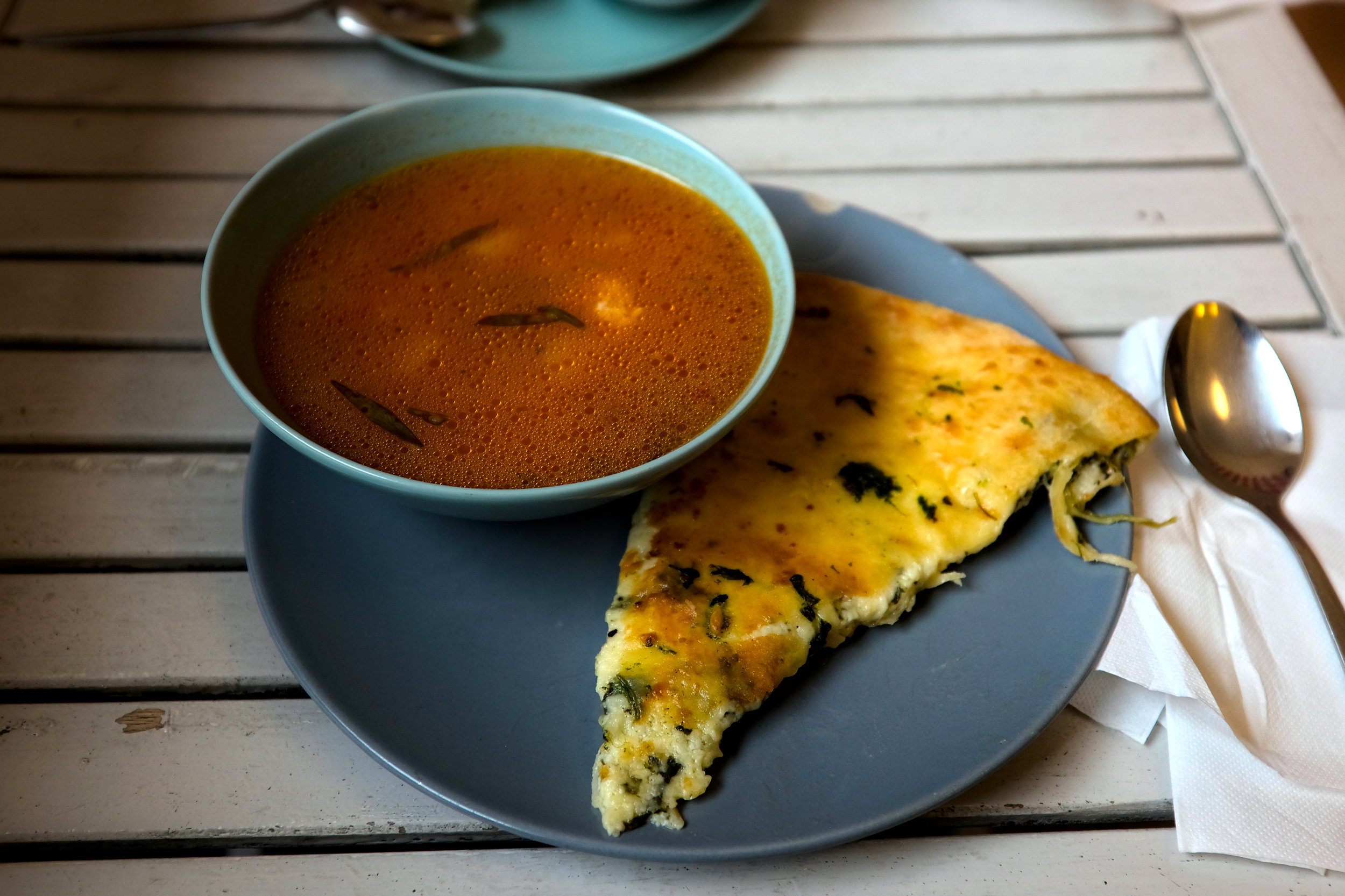 A bowl of soup with khachapuri