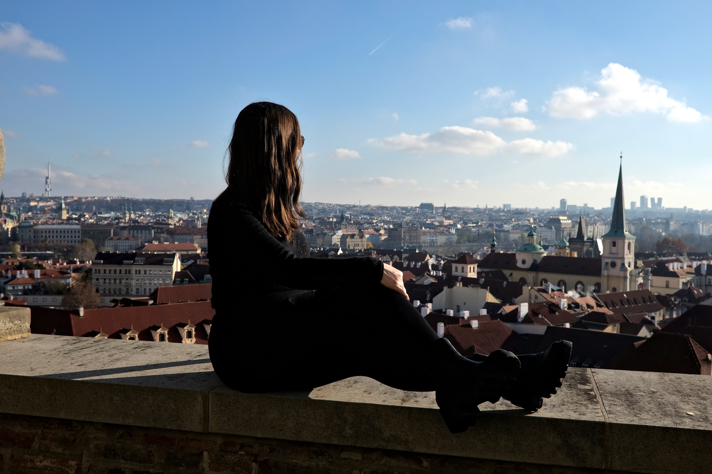 Alyssa sits and looks out over Prague from Prague Castle