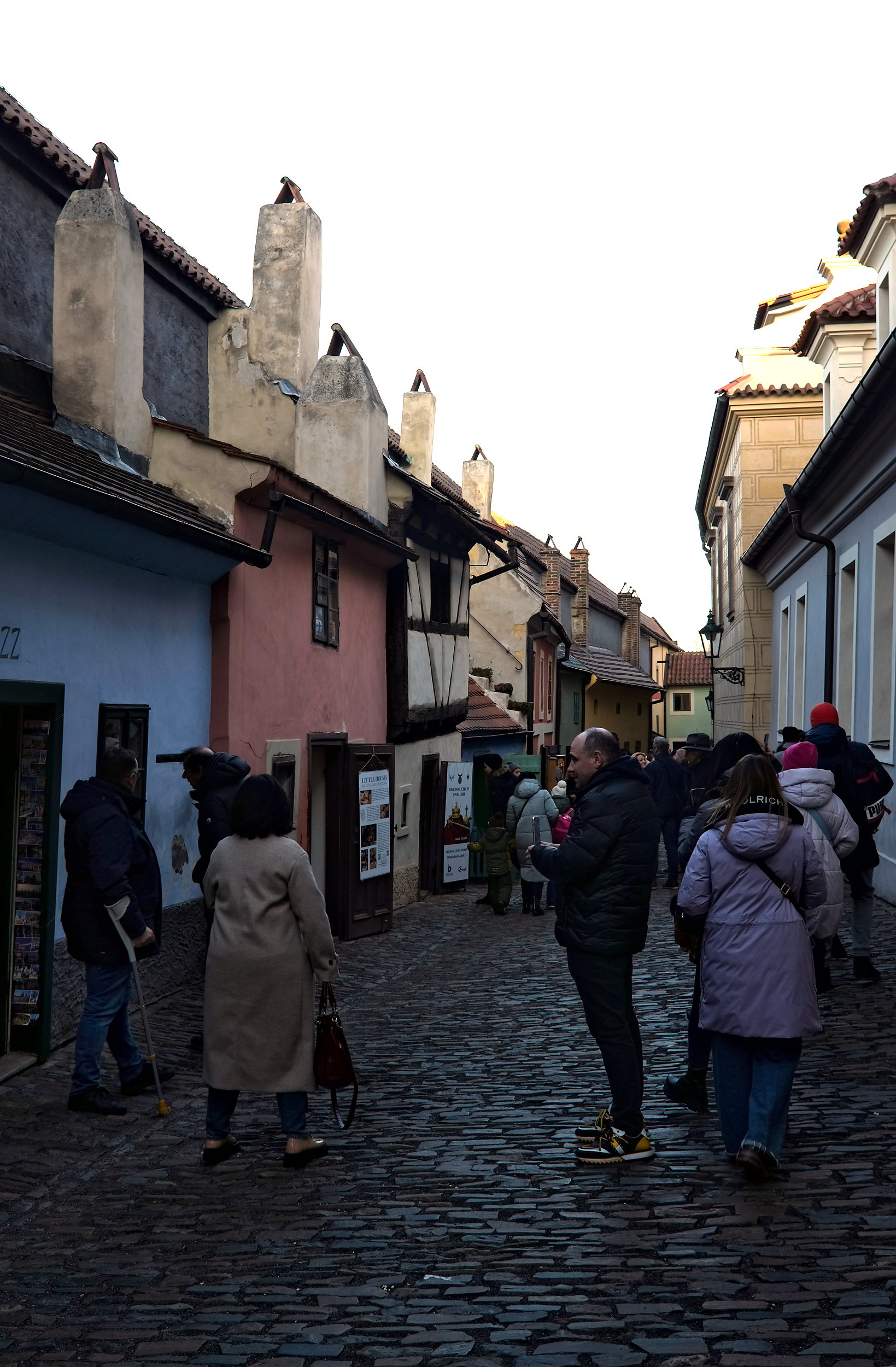 A group of people walk down Golden Lane