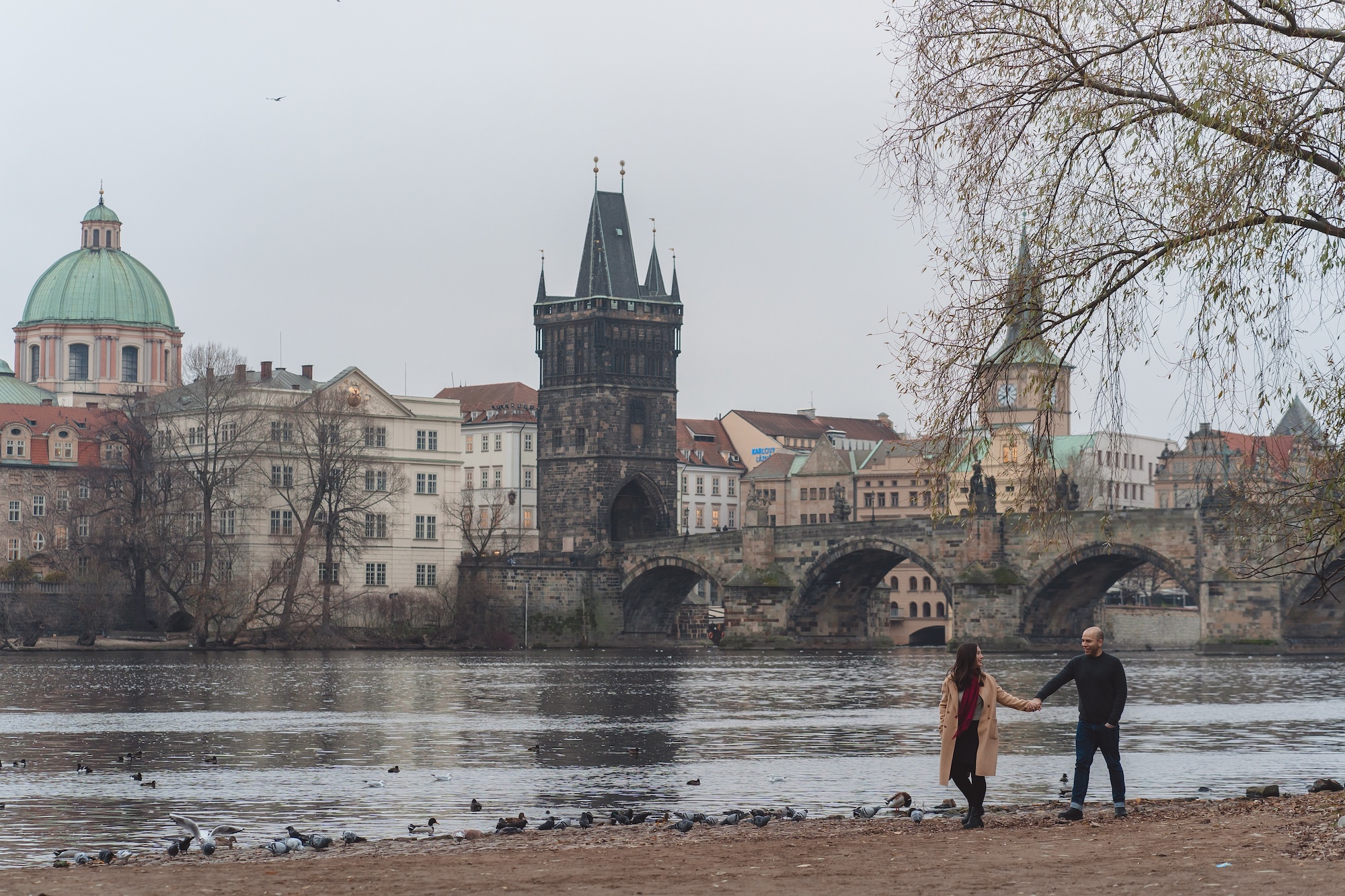 Alyssa and Michael walk along the Vltava River in Prague