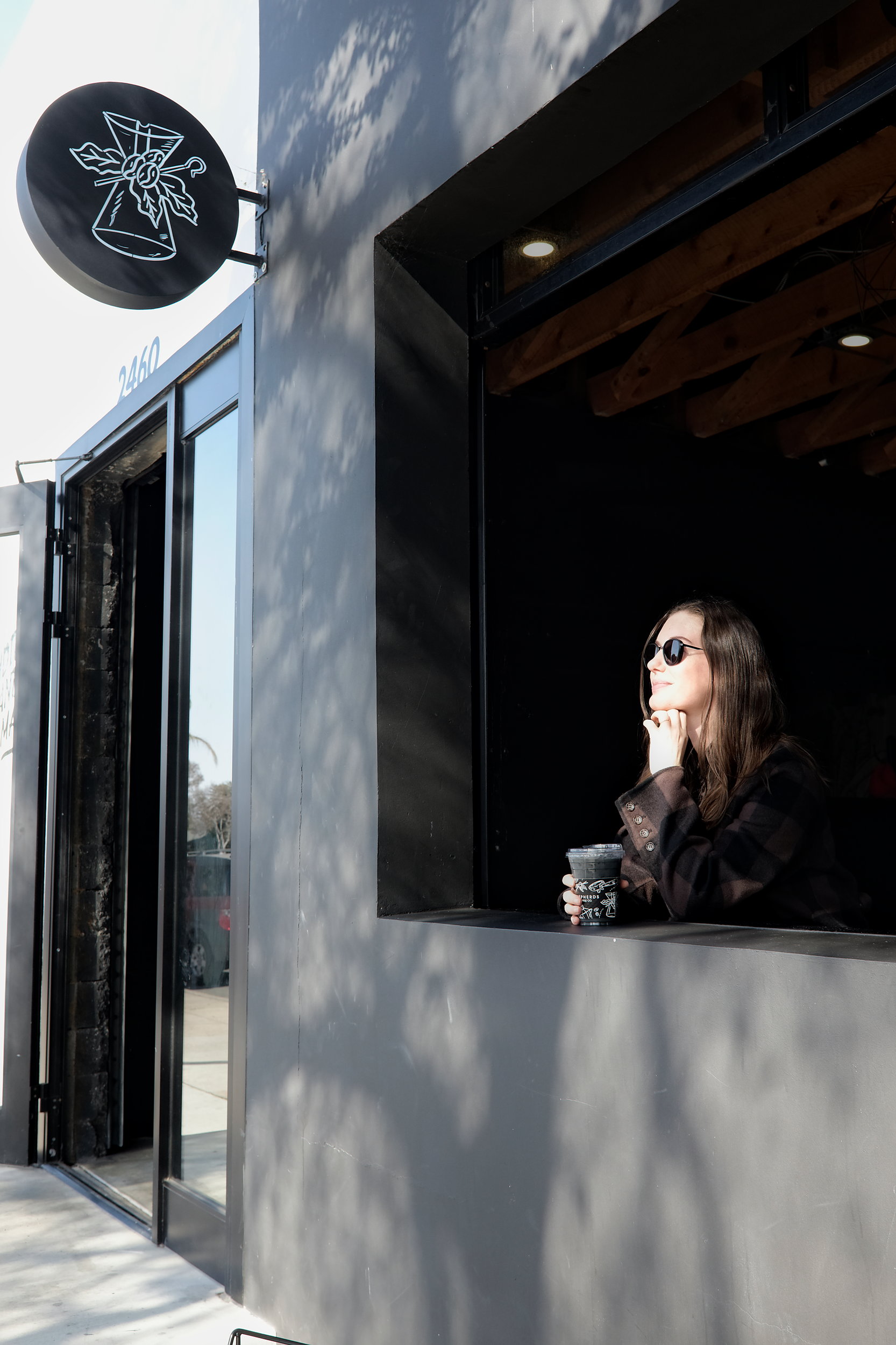 Alyssa sits in an open coffee shop window