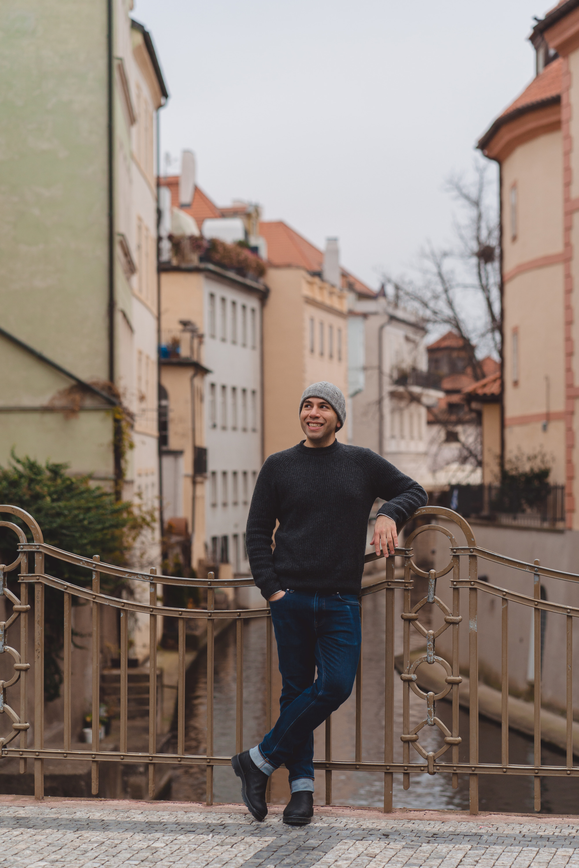 The author, Michael, wears a cashmere sweater, blue jeans, and boots in Prague