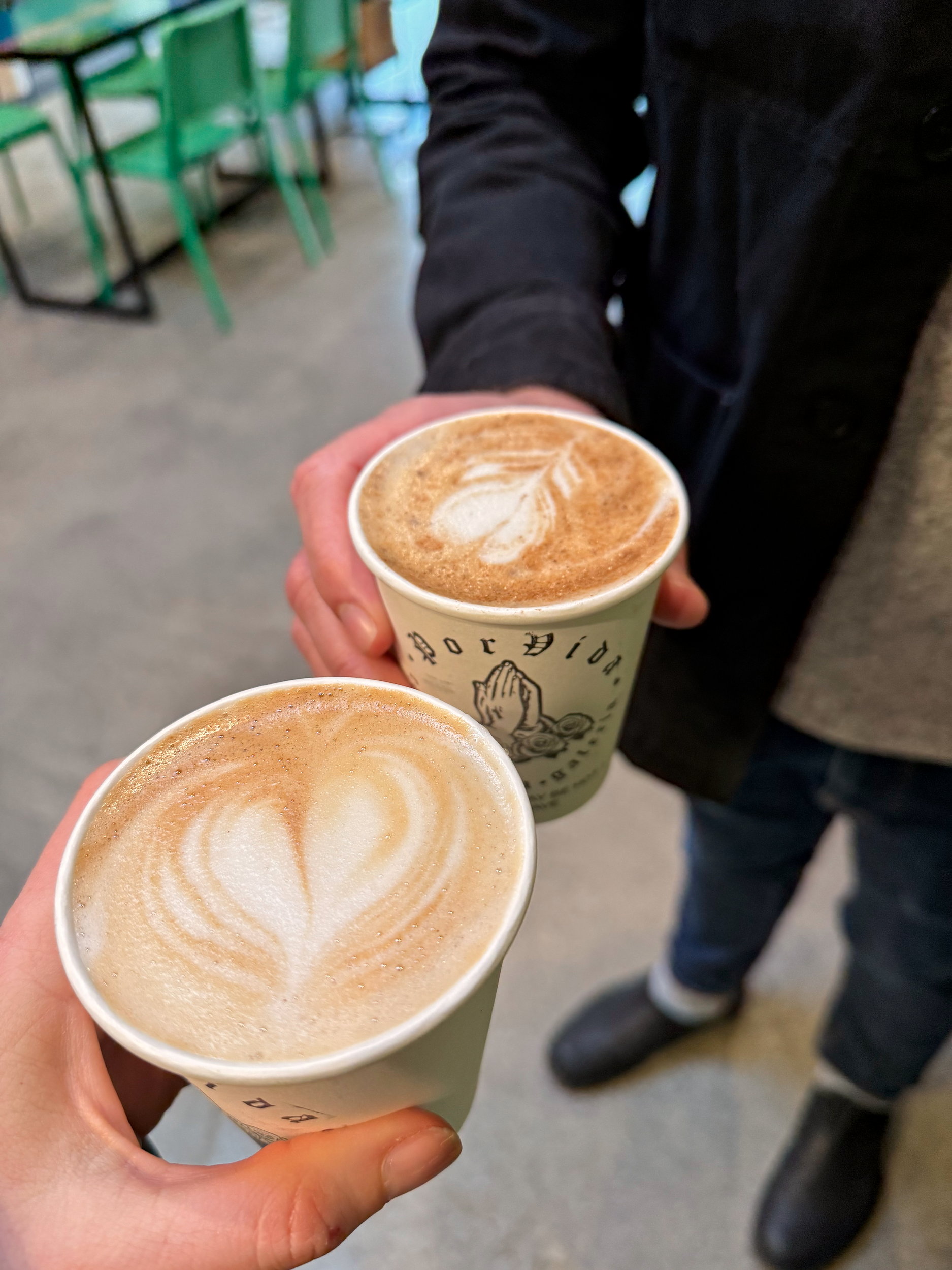 Alyssa and Michael "cheers" with their lattes at Por Vida