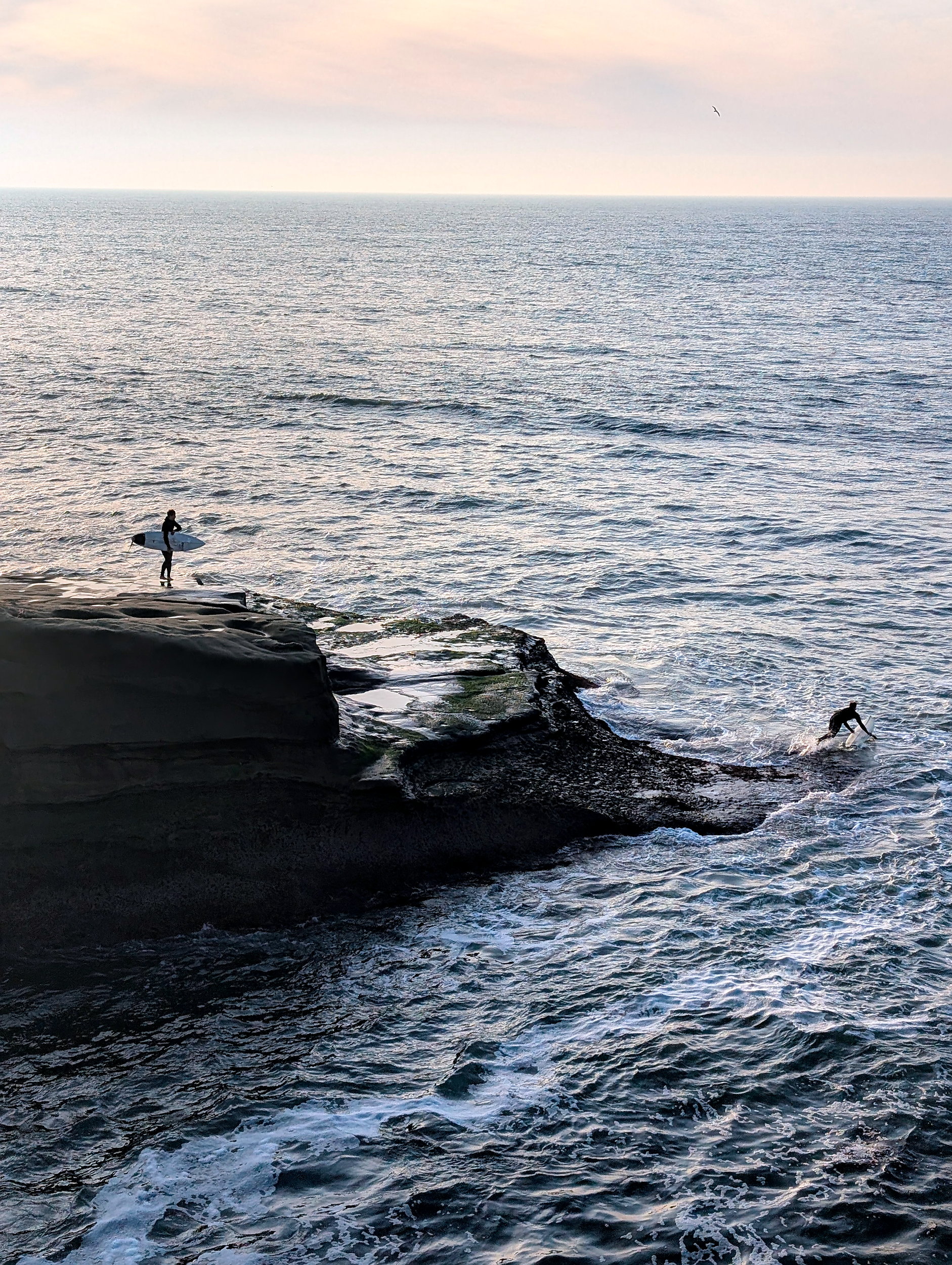 Surfers getting into the water at Sunset Cliffs