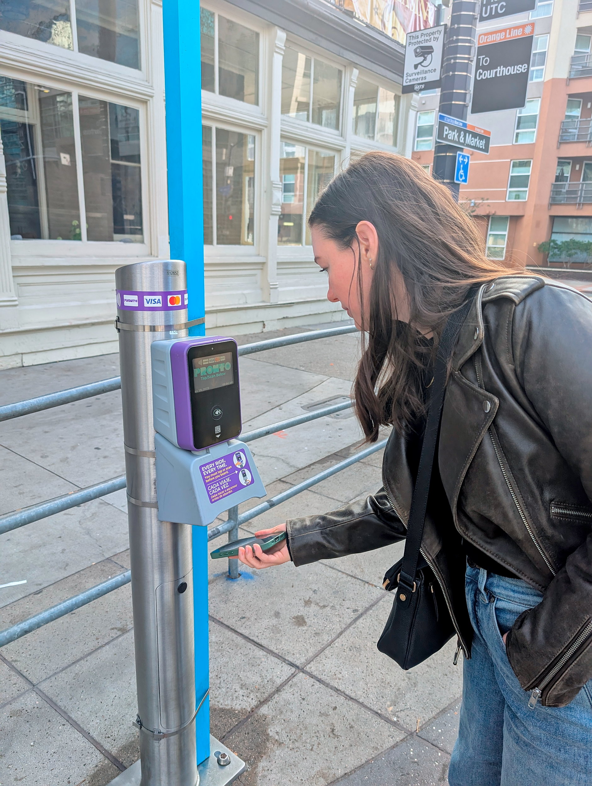 Alyssa validates her transit pass in San Diego