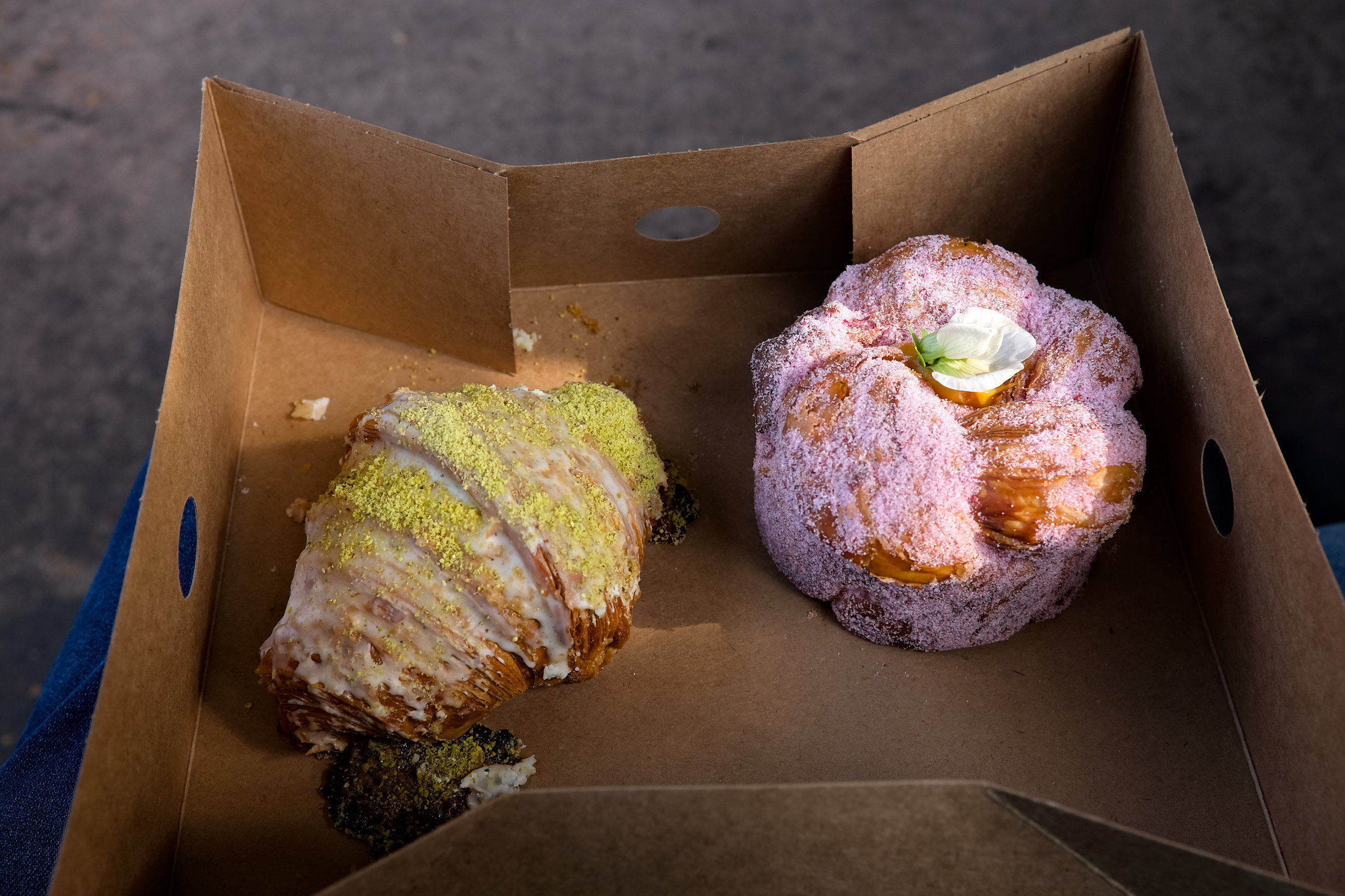 A pistachio citrus croissant and a passionfruit dulce de leche pastry