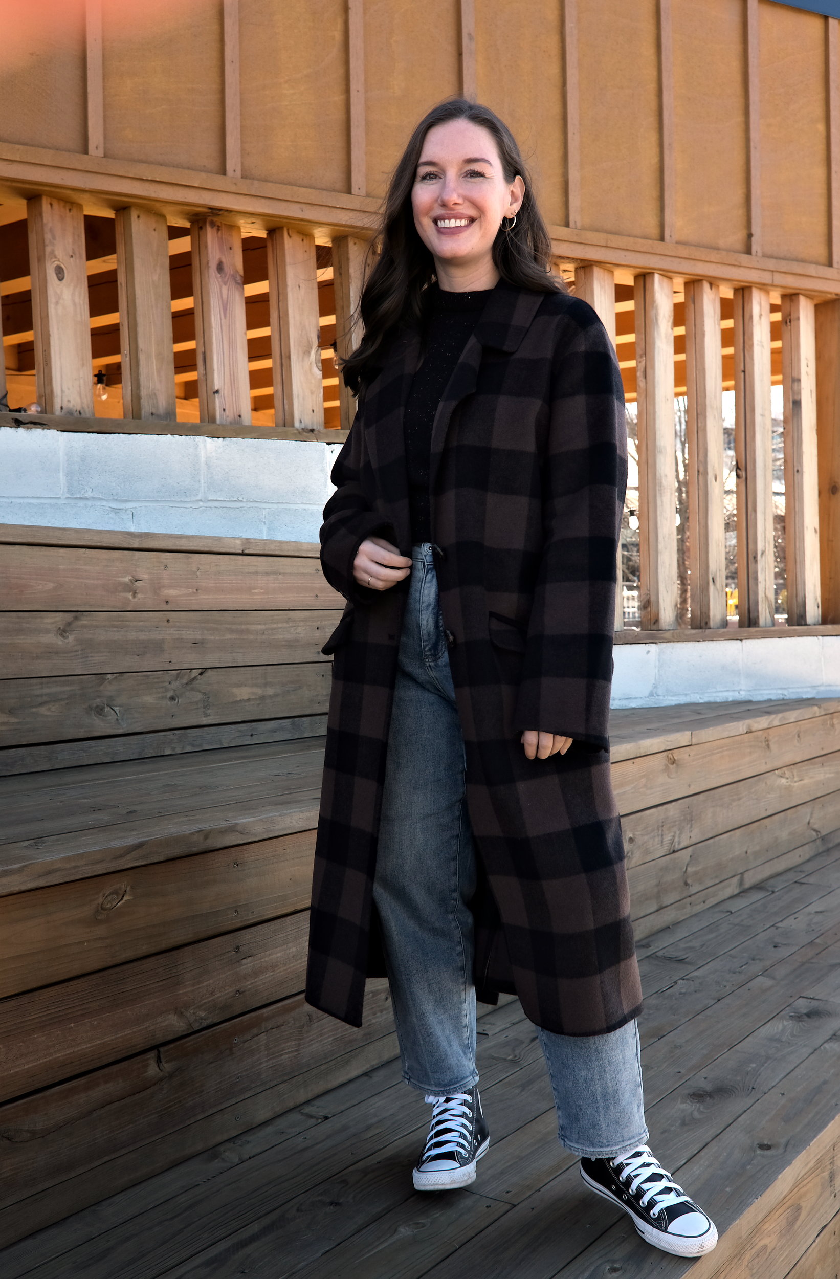 Alyssa wears a brown and black check coat from Universal Standard called the Double Face Luxe Coat