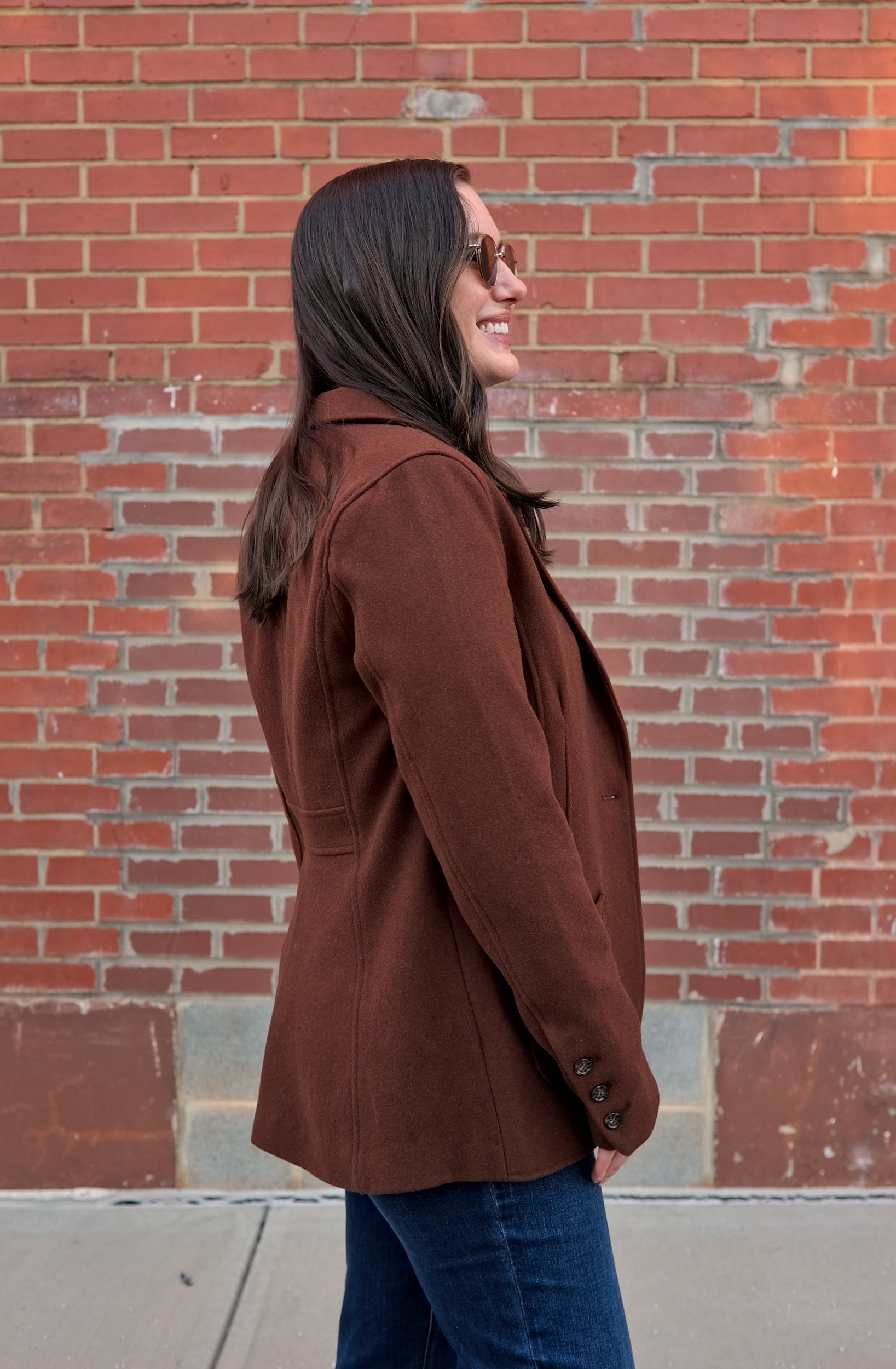 Alyssa wears the Kidjo Tailored Wool Jacket and turns in profile to the camera