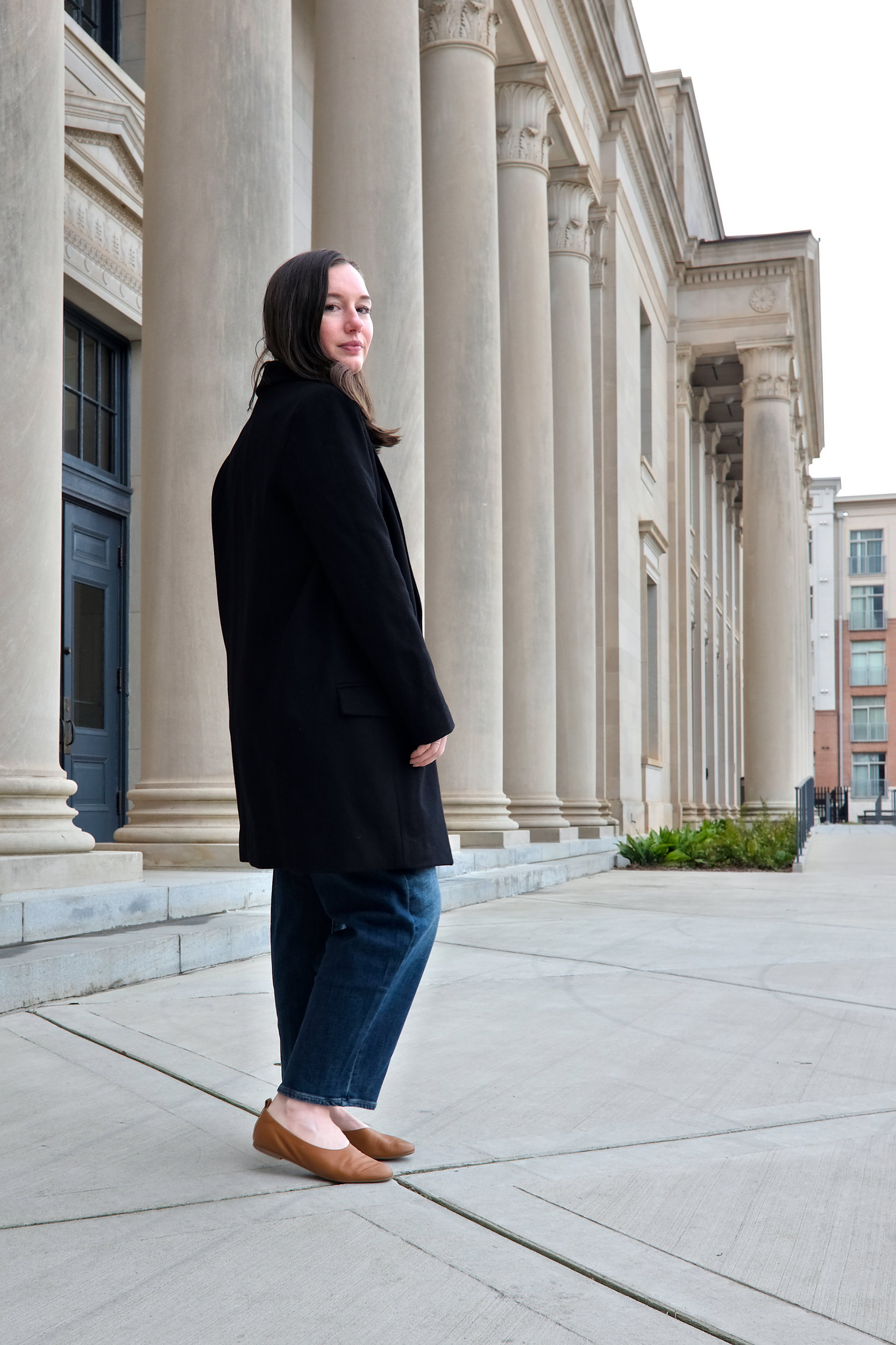 Alyssa wears the Harlow Classic Wool Coat and turns away from the camera