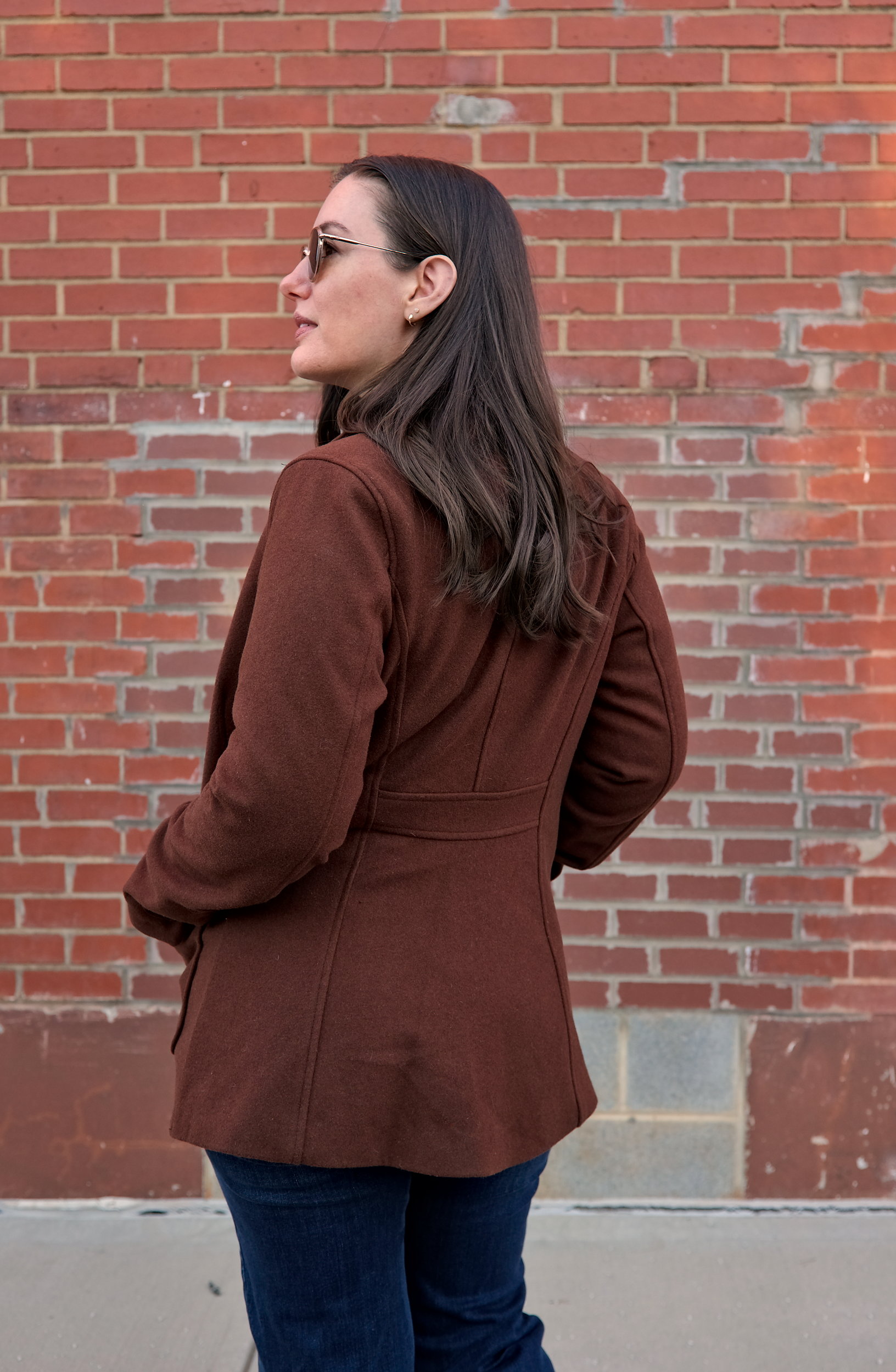 Alyssa wears the Kidjo Tailored Wool Jacket and faces away from the camera